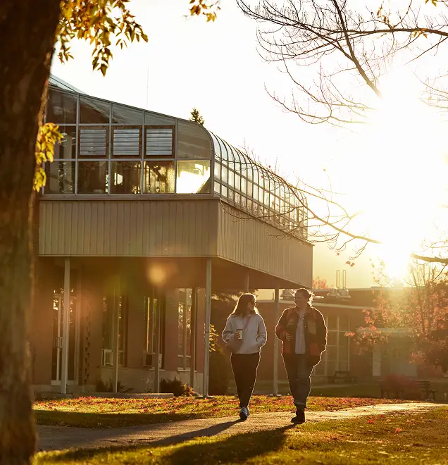 two women walking on campus
